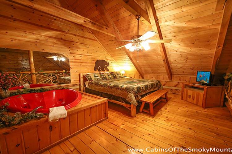 Bedroom with bed and tub in cabin.