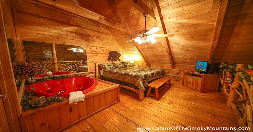 Bed and tub in cabin room.